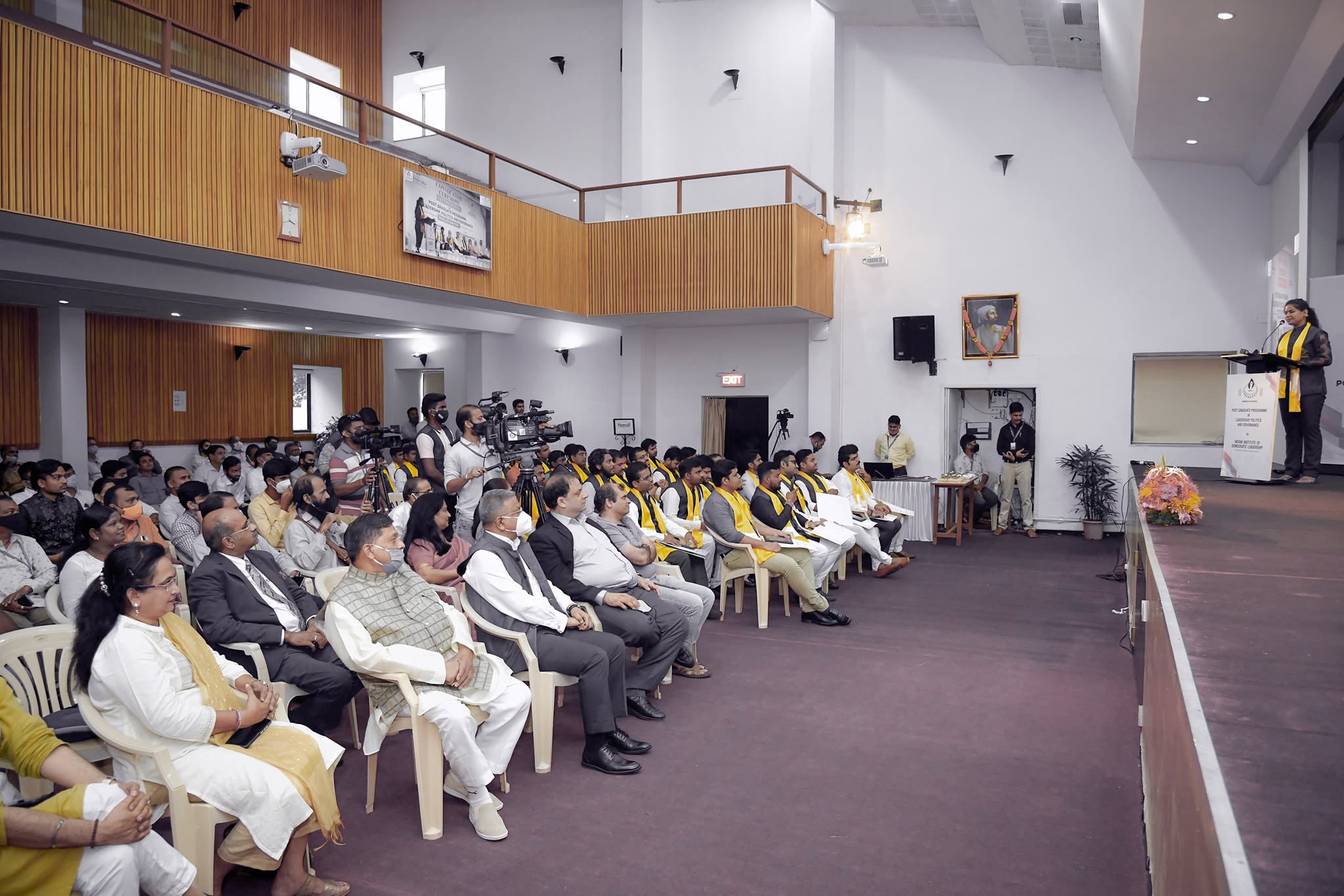 Wide documentary photograph of the audience and stage at an IIDL programme