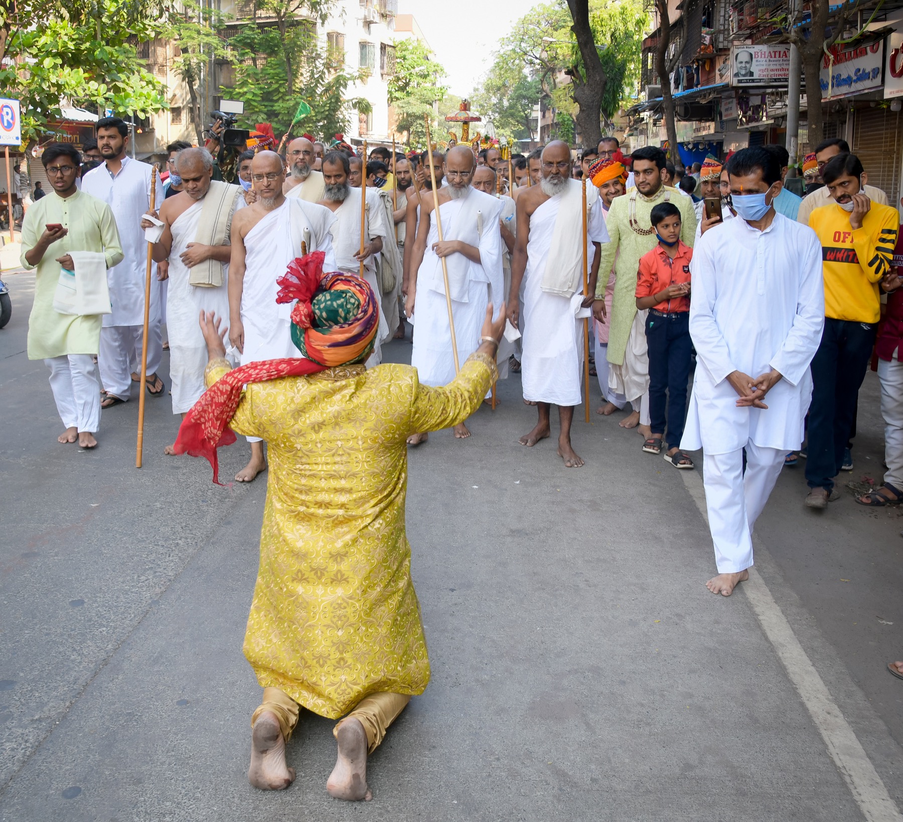 A participant bows during an outdoor ritual